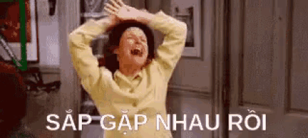 a woman is laughing with her hands in the air and a foreign language .