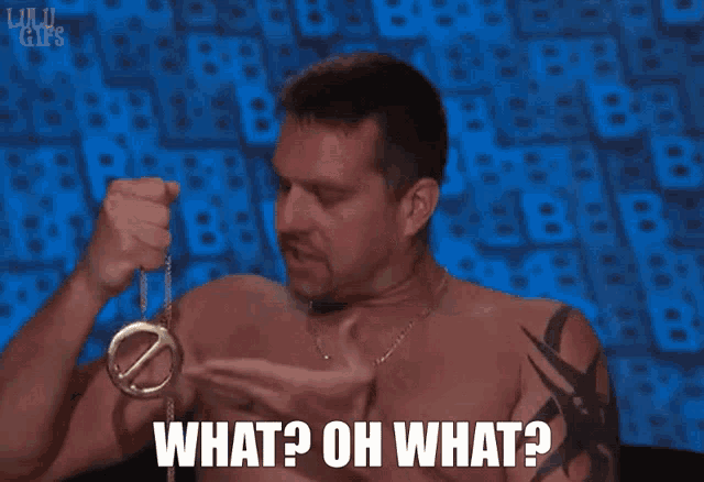 a shirtless man is holding a gold ring in his hand and says what oh what