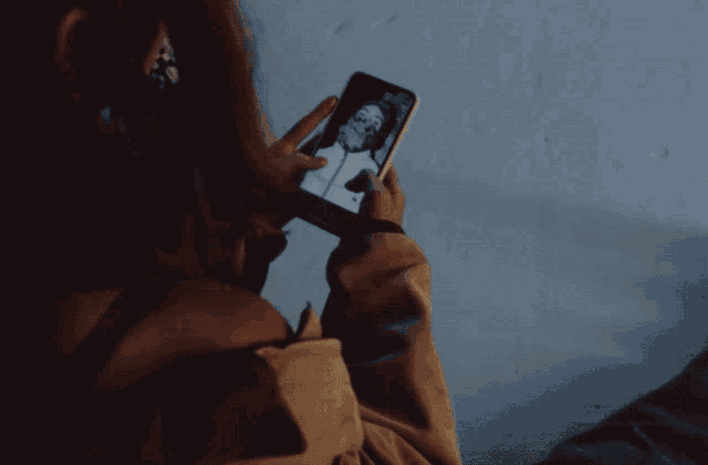 a woman is taking a selfie on her phone