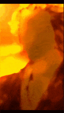 a close up of a person 's face in front of a sunset