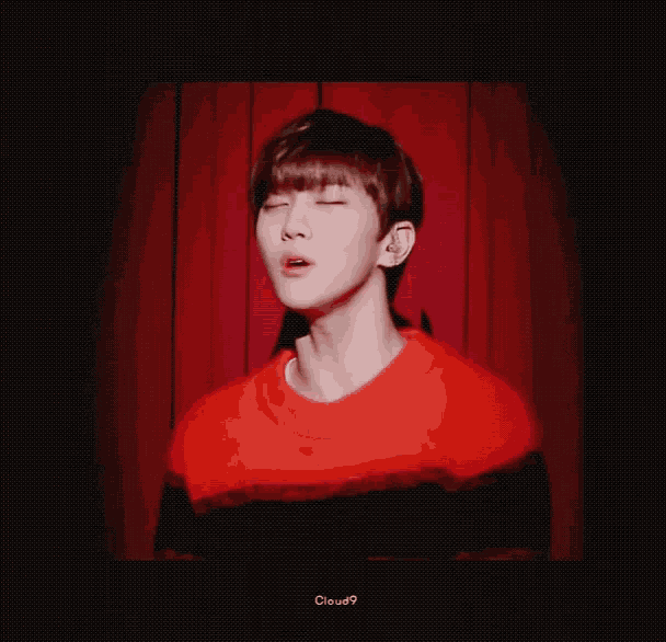 a man in a red and black sweater is standing in front of a red curtain with his eyes closed and the words cloud9 below him