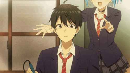 a boy in a suit and tie is standing next to a girl in a choker