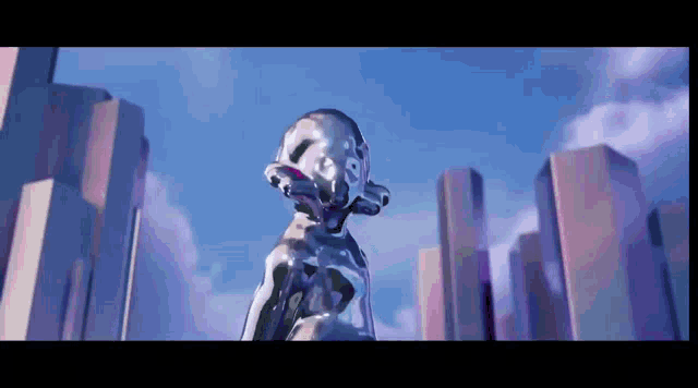 a statue in front of a city skyline with a blue sky in the background