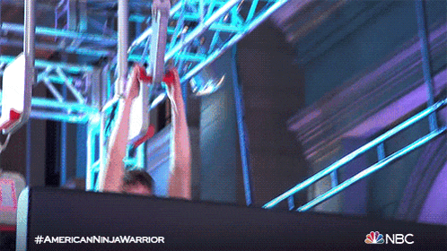 a man is doing a ninja warrior exercise with a nbc logo in the background