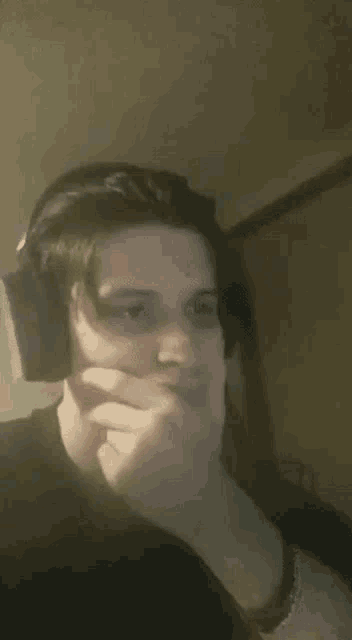 a man wearing headphones is making a funny face .