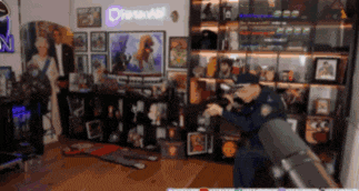 a man wearing a virtual reality headset is playing a video game in a room with a sign that says digital
