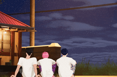 a group of people sitting in front of a house looking at the stars