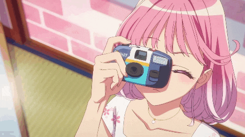a girl with pink hair is taking a photo with a polaroid camera