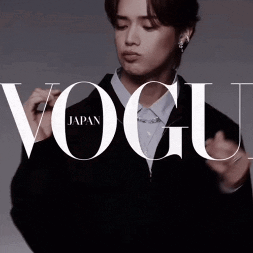 a man stands in front of a vogue japan ad