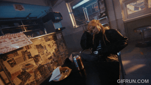 a gif from gifrun.com shows a woman sitting in a chair