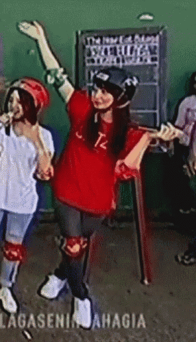 a girl wearing a red shirt that says tz on it