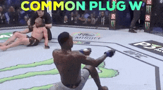 a man is kneeling on the ground in a boxing ring with the words common plug w written above him