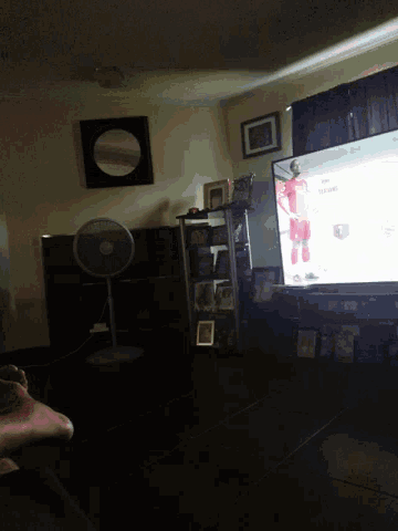 a fan is sitting in a dark room with a mirror