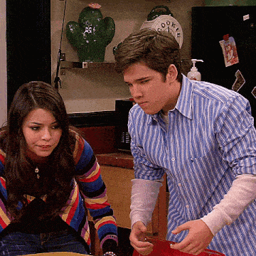 a man in a blue striped shirt stands next to a woman in a striped sweater