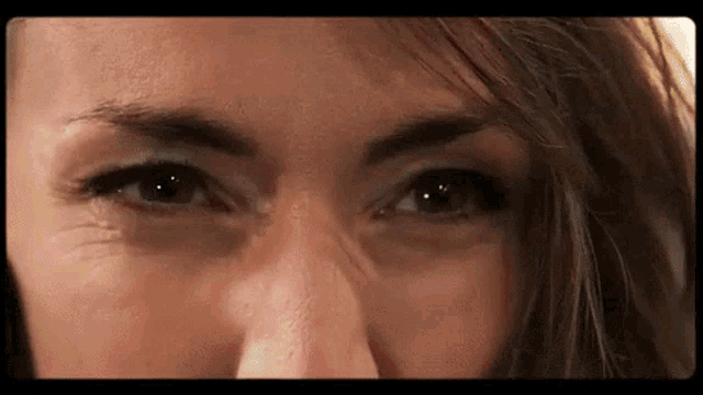 a close up of a woman 's eyes with a slight wrinkle