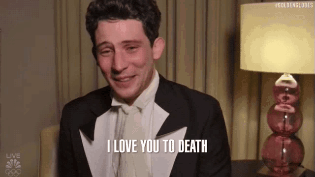 a man in a tuxedo and bow tie says i love you to death