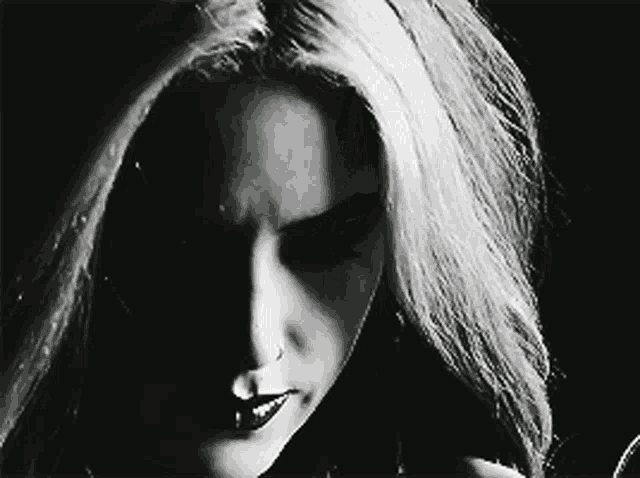 a woman 's face is shown in a black and white photo
