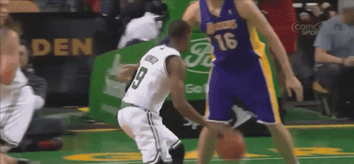 a basketball player wearing a number 16 jersey dribbles the ball