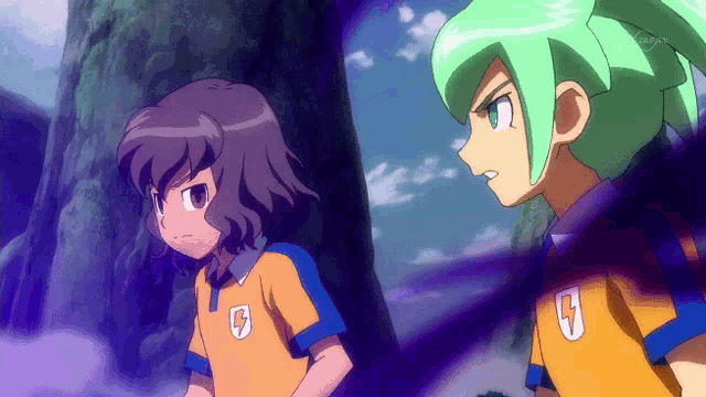 two anime characters with the letter g on their shirts are standing next to each other