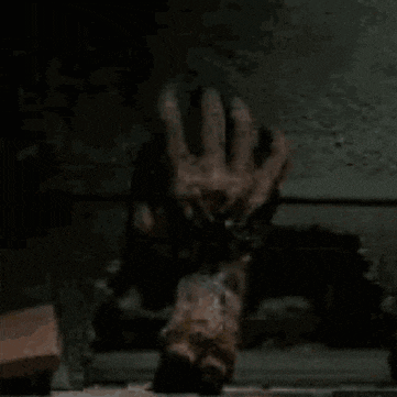 a person is laying on their back and giving the middle finger .