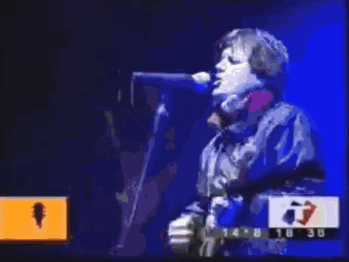 a man singing into a microphone with a time of 14:38