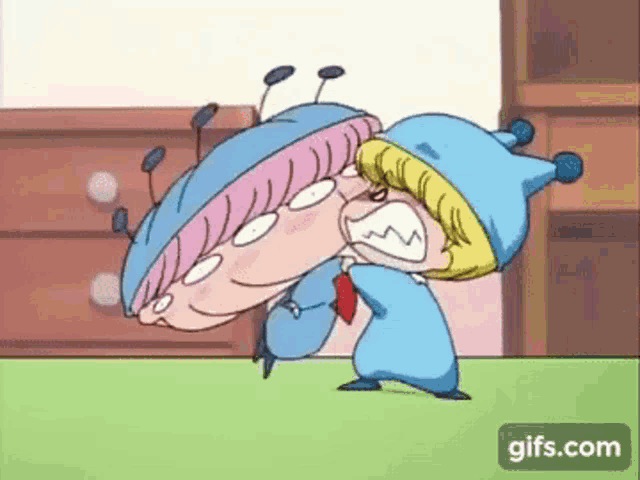 a couple of cartoon characters are fighting each other on a carpet .