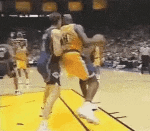 a group of basketball players are playing basketball on a court .