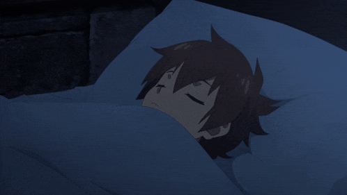 a cartoon character sleeping in a bed with a blue blanket