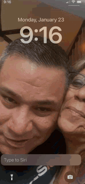 a phone screen shows a man and a woman on monday january 23
