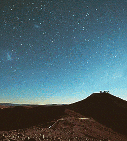 a night sky filled with lots of stars and a mountain in the foreground