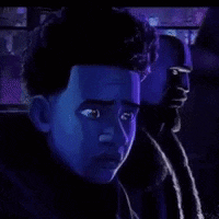 a close up of a person 's face in a dark room with a purple background .