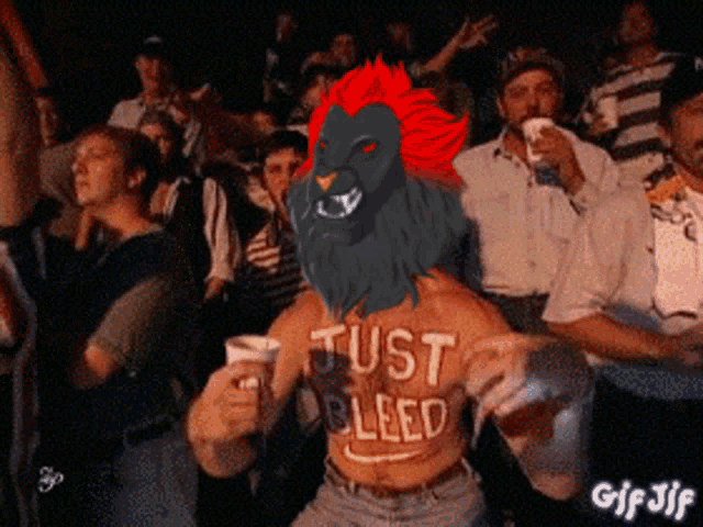 a man with a lion on his head is wearing a just bleed shirt