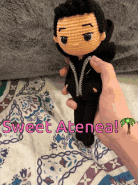 a person is holding a crocheted doll with the words sweet atenea written on it