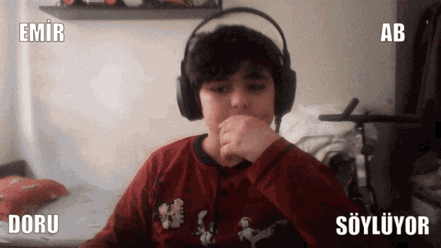 a young boy wearing headphones with the words emir doru and ab behind him