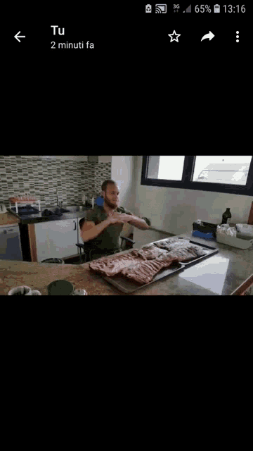a man is sitting at a table with a tray of meat in front of him