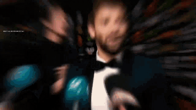 a blurry picture of a man in a tuxedo