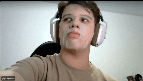 a man wearing headphones has a mask on his face and the name ygt_ayazzz is on the bottom right
