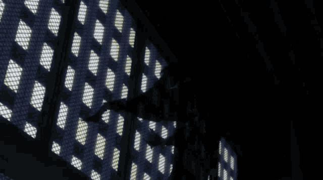 a dark room with a grid of squares and dots
