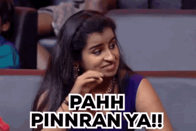 a woman is sitting in a theatre with the words pahh pinnran ya written on her face