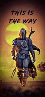 the mandalorian from star wars is walking in the desert with a sword and a helmet .