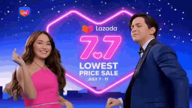 a man in a suit and a woman in a pink dress are dancing in front of a sign that says lowest price sale .