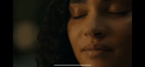 a close up of a person 's face with their eyes closed .