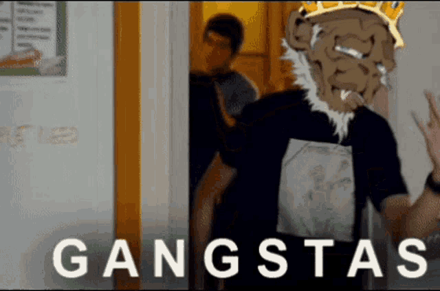 a man with a crown on his head is standing in front of a wall that says gangsta