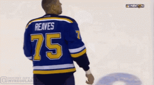 a hockey player wearing a blue jersey with the number 75 on it