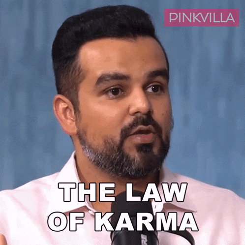 a man with a beard is talking into a microphone with the words " the law of karma " below him