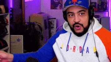 a man wearing headphones and a sweatshirt that says daridra