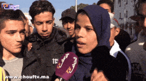 a group of people are gathered in front of a microphone that says tv on it
