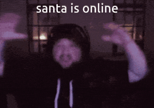 a man in a hoodie is dancing with the words santa is online behind him