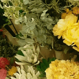 a bunch of flowers including yellow and pink