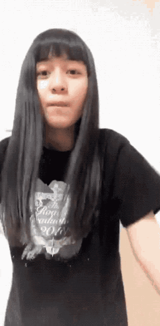 a girl with long black hair is wearing a black t-shirt that says rock 'n ' roll .